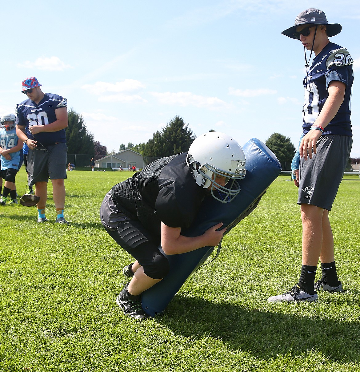 Cole Cooper, a seventh-grade student at Woodland Middle School, practices tackling at Lake City High School&#146;s Junior Tackle camp.