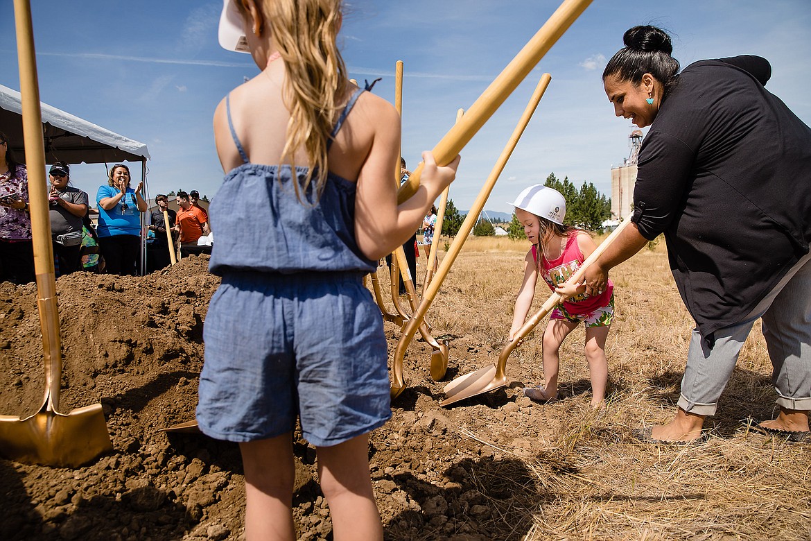 Jaylee McFadden gets ready to shovel dirt with the help of Marimn Health Wellness Center Director Lindsey Holt. (JEROME A. POLLOS/Special to The Press)