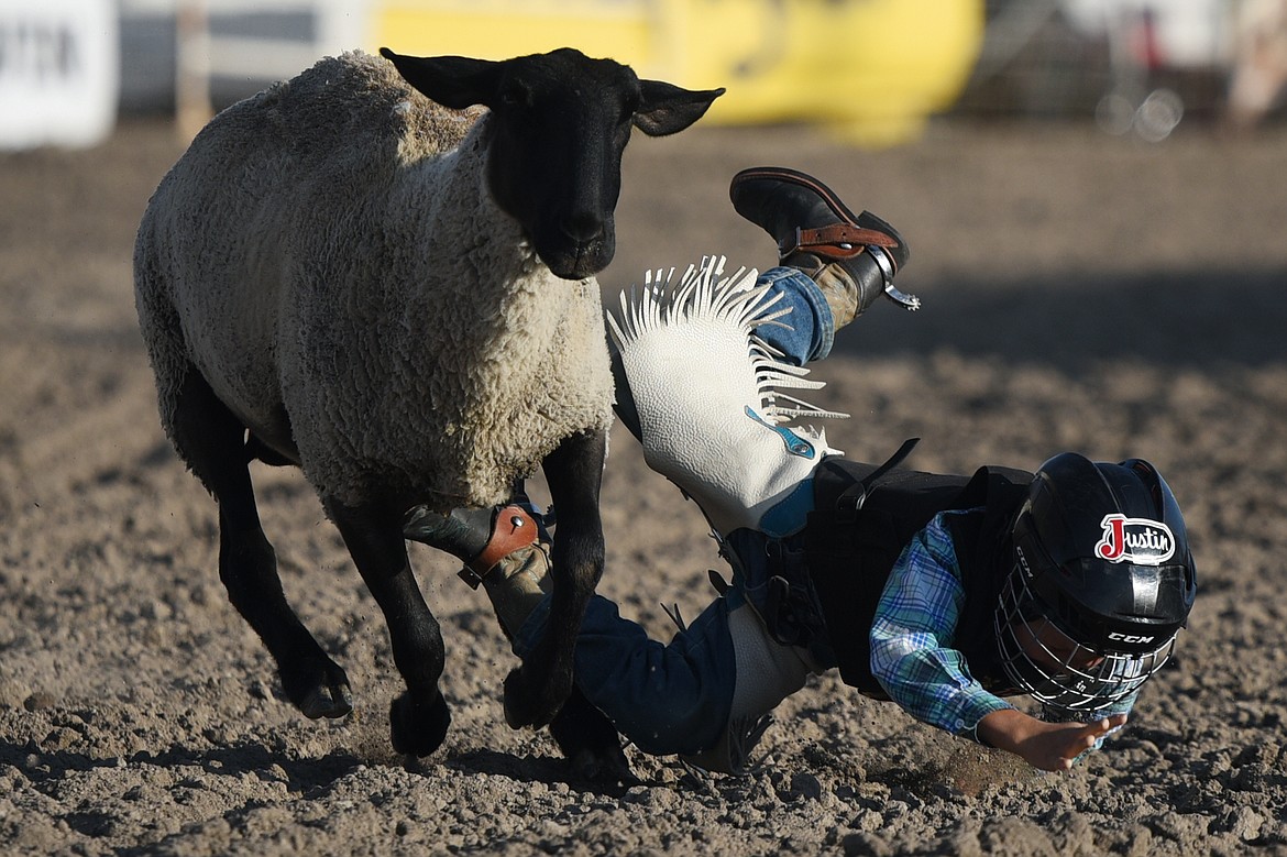 A child competitor hits the dirt in the Justin Mutton Bustin' event at the Ram PRCA Rodeo at the Northwest Montana Fair &amp; Rodeo on Thursday. (Casey Kreider/Daily Inter Lake)