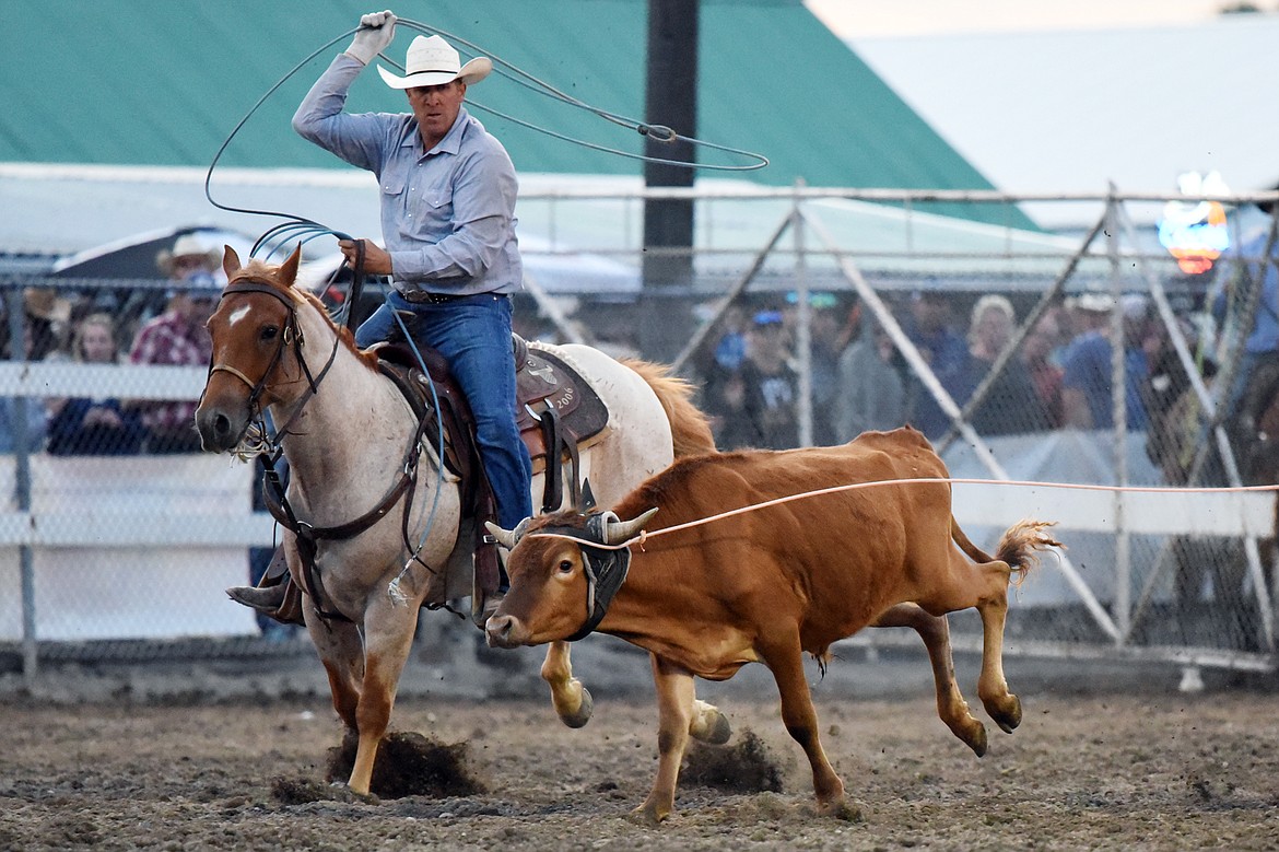 Hank Hollenbeck, from Molt, ropes the hind legs of a steer during team roping with partner Radley Day, from Volborg, at the Northwest Montana Fair PRCA Rodeo at the Flathead County Fairgrounds on Saturday. (Casey Kreider/Daily Inter Lake)