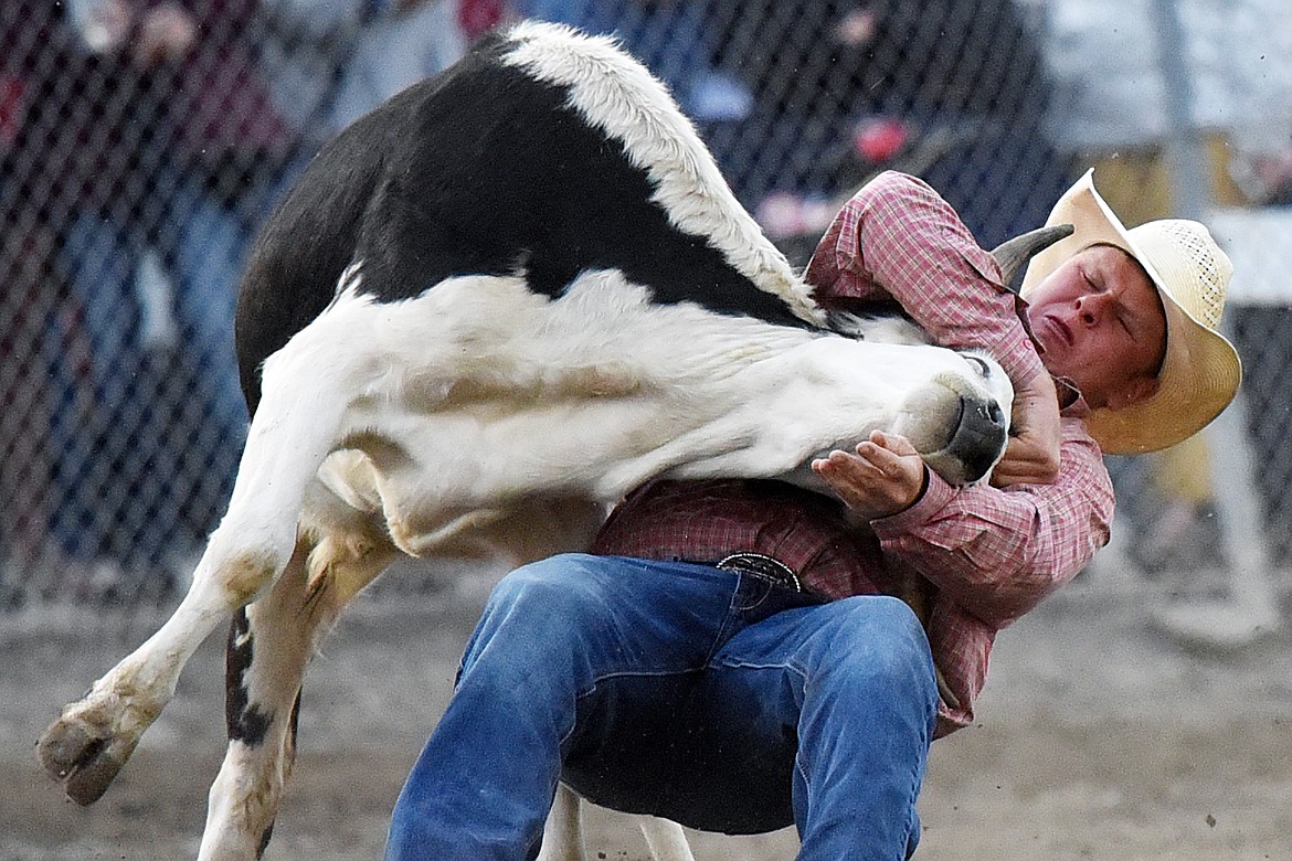 Riley Joyce, from Geraldine, Montana, brings his steer to the ground during steer wrestling at the Northwest Montana Fair PRCA Rodeo at the Flathead County Fairgrounds on Saturday. (Casey Kreider/Daily Inter Lake)