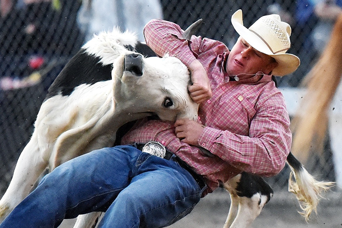 Riley Joyce, from Geraldine, Montana, brings his steer to the ground during steer wrestling at the Northwest Montana Fair PRCA Rodeo at the Flathead County Fairgrounds on Saturday. (Casey Kreider/Daily Inter Lake)