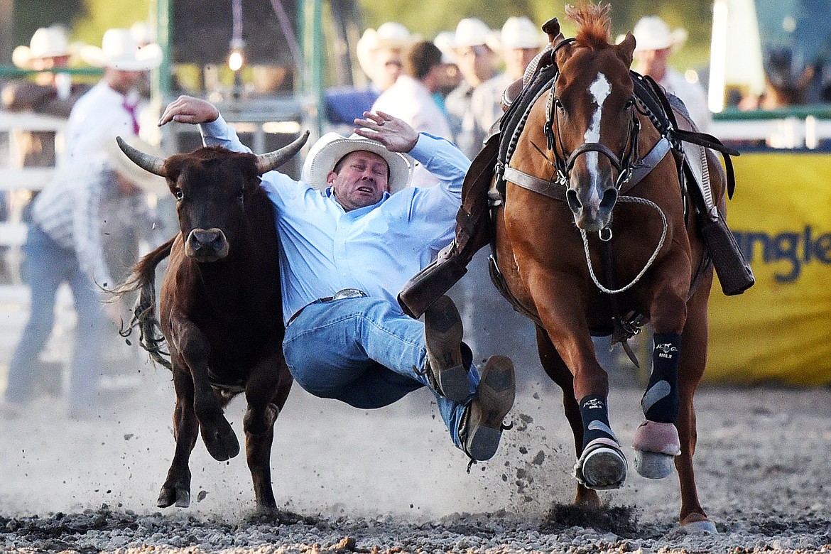 Walt Anseth can't hang on to his steer in steer wrestling at the Ram PRCA Rodeo at the Northwest Montana Fair &amp; Rodeo on Thursday. (Casey Kreider/Daily Inter Lake)