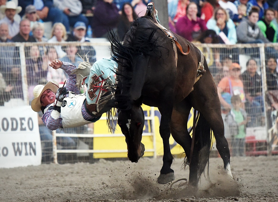 Richmond Champion, from The Woodlands, Texas, is thrown from his horse Chaperone during bareback riding at the Northwest Montana Fair PRCA Rodeo at the Flathead County Fairgrounds on Friday. (Casey Kreider/Daily Inter Lake)