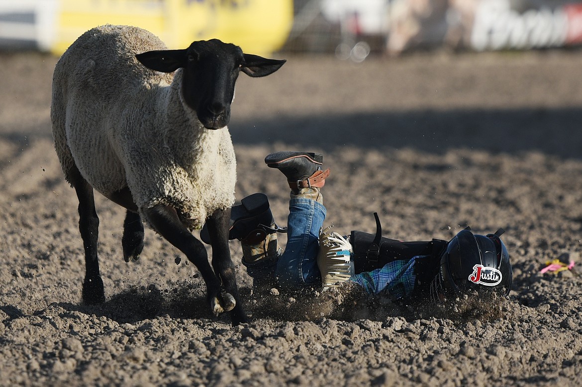 A child competitor hits the dirt in the Justin Mutton Bustin' event at the Ram PRCA Rodeo at the Northwest Montana Fair &amp; Rodeo on Thursday. (Casey Kreider/Daily Inter Lake)