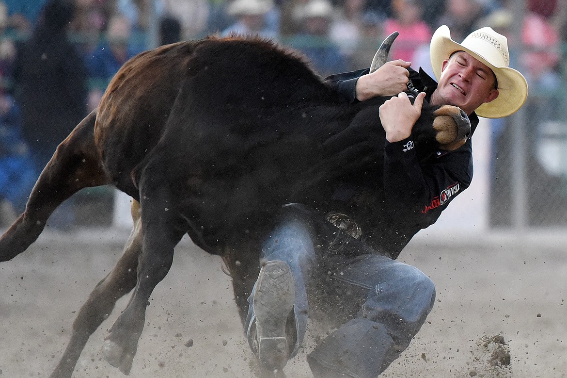 Ty Erickson, from Helena, brings his steer to the ground during steer wrestling at the Northwest Montana Fair PRCA Rodeo at the Flathead County Fairgrounds on Friday. (Casey Kreider/Daily Inter Lake)