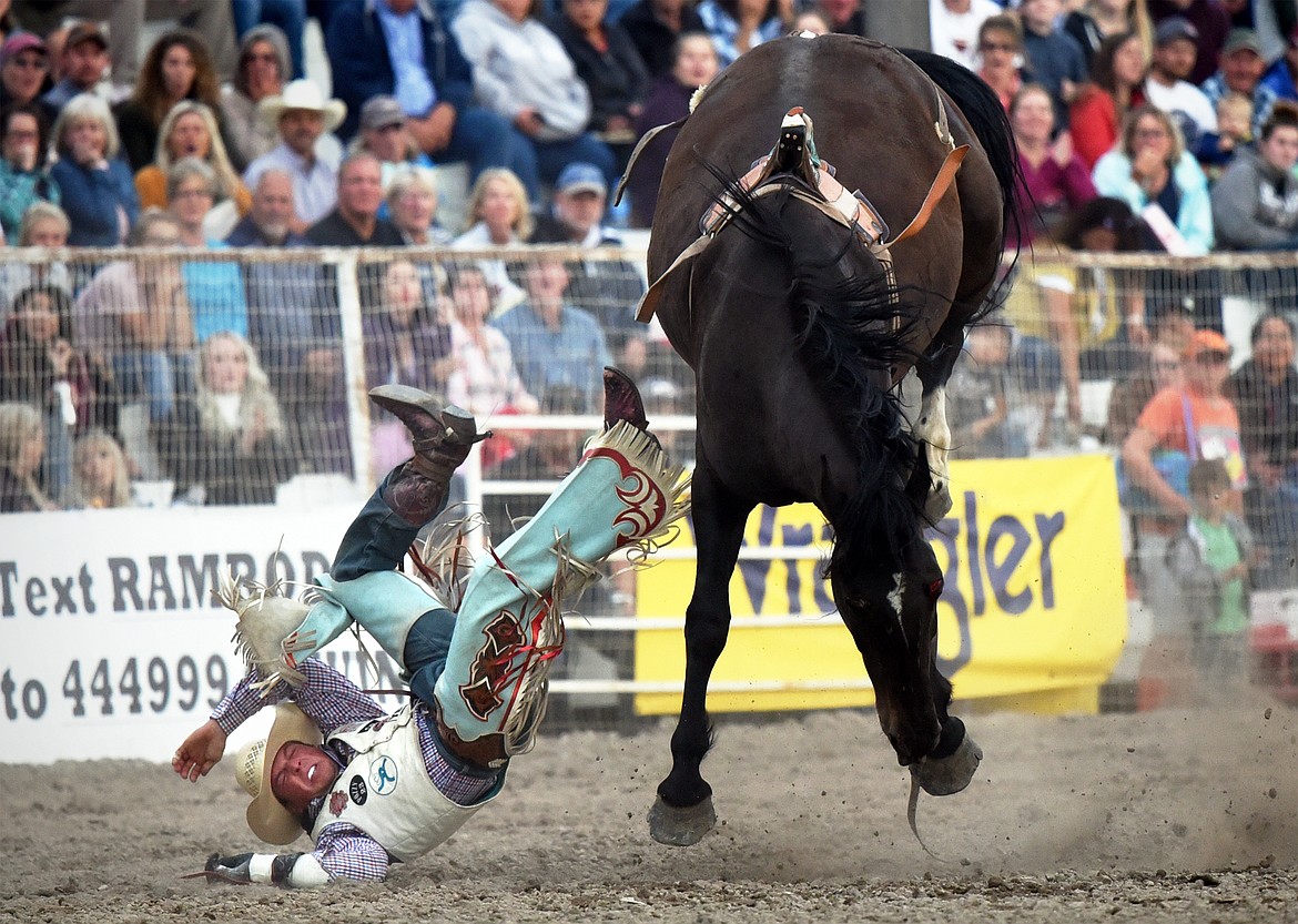 Richmond Champion, from The Woodlands, Texas, is thrown from his horse Chaperone during bareback riding at the Northwest Montana Fair PRCA Rodeo at the Flathead County Fairgrounds on Friday. (Casey Kreider/Daily Inter Lake)