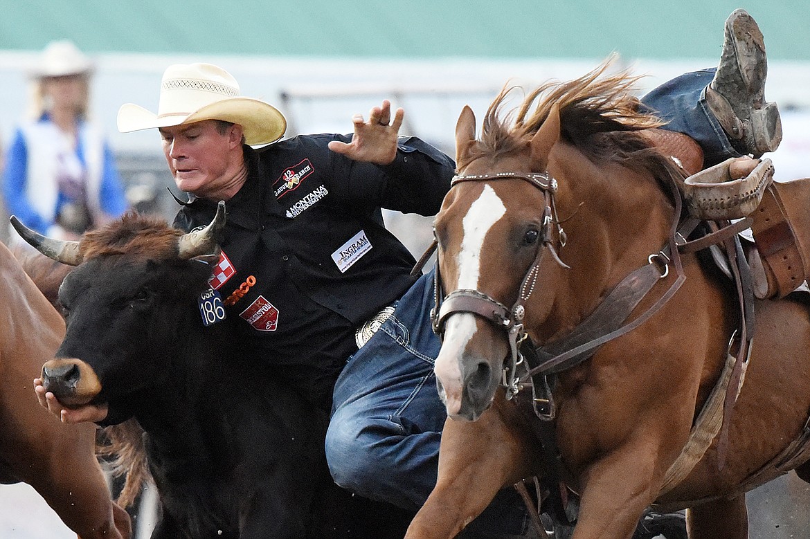 Ty Erickson, from Helena, competes in steer wrestling at the Northwest Montana Fair PRCA Rodeo at the Flathead County Fairgrounds on Friday. (Casey Kreider/Daily Inter Lake)
