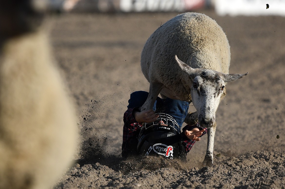 A child competitor hits the dirt in the Justin Mutton Bustin' event at the Ram PRCA Rodeo at the Northwest Montana Fair &amp; Rodeo on Thursday. (Casey Kreider/Daily Inter Lake)