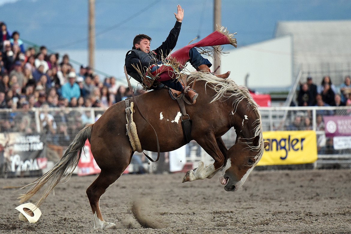 Caleb Bennett, from Corvallis, Montana, holds on to his horse Critical Smile during bareback riding at the Northwest Montana Fair PRCA Rodeo at the Flathead County Fairgrounds on Friday. (Casey Kreider/Daily Inter Lake)