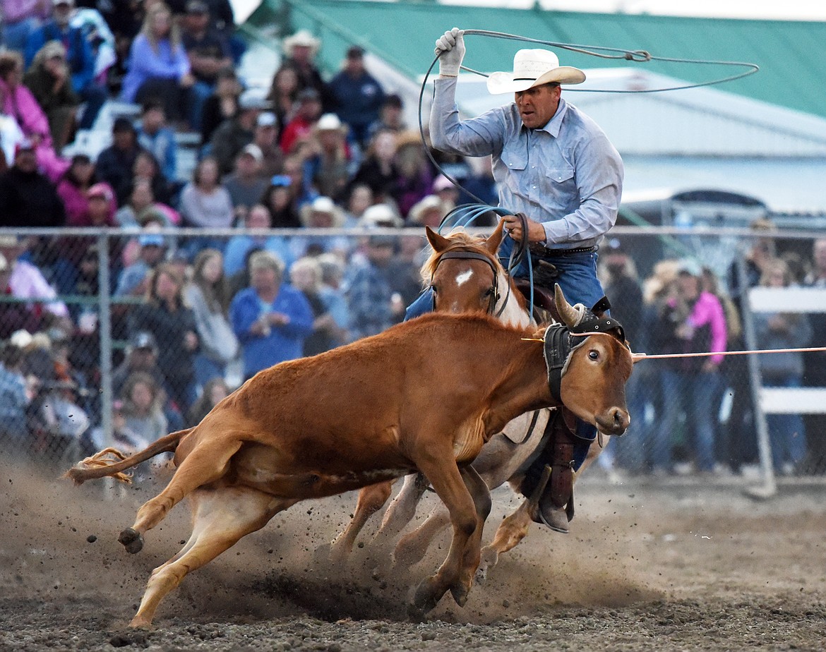 Hank Hollenbeck, from Molt, ropes the hind legs of a steer during team roping with partner Radley Day, from Volborg, at the Northwest Montana Fair PRCA Rodeo at the Flathead County Fairgrounds on Saturday. (Casey Kreider/Daily Inter Lake)