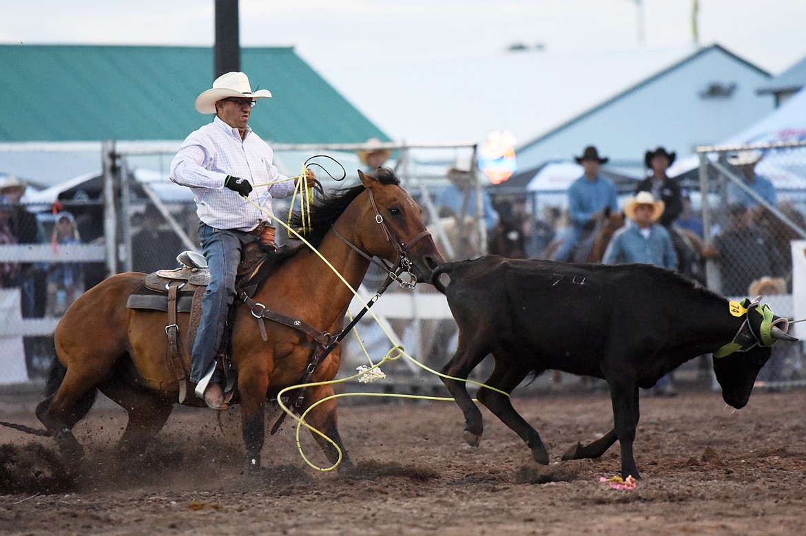Kory Mytty, from Lolo, ropes the hind legs of a steer during team roping with partner Kade Sherwood, from Wilson, Texas, at the Northwest Montana Fair PRCA Rodeo at the Flathead County Fairgrounds on Saturday. (Casey Kreider/Daily Inter Lake)