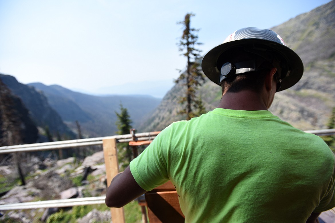 A worker transports materials along the upper level catwalk of Sperry Chalet in Glacier National Park on Thursday, Aug. 8. (Casey Kreider/Daily Inter Lake)