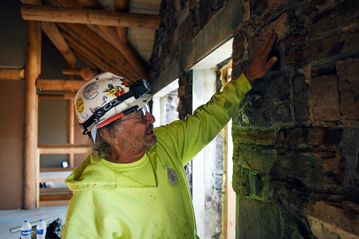 Alex Gladstone, with Anderson Masonry, describes the thermal shock to the stone caused by the intense heat of the Sprague fire inside Sperry Chalet in Glacier National Park on Thursday, Aug. 8. (Casey Kreider/Daily Inter Lake)