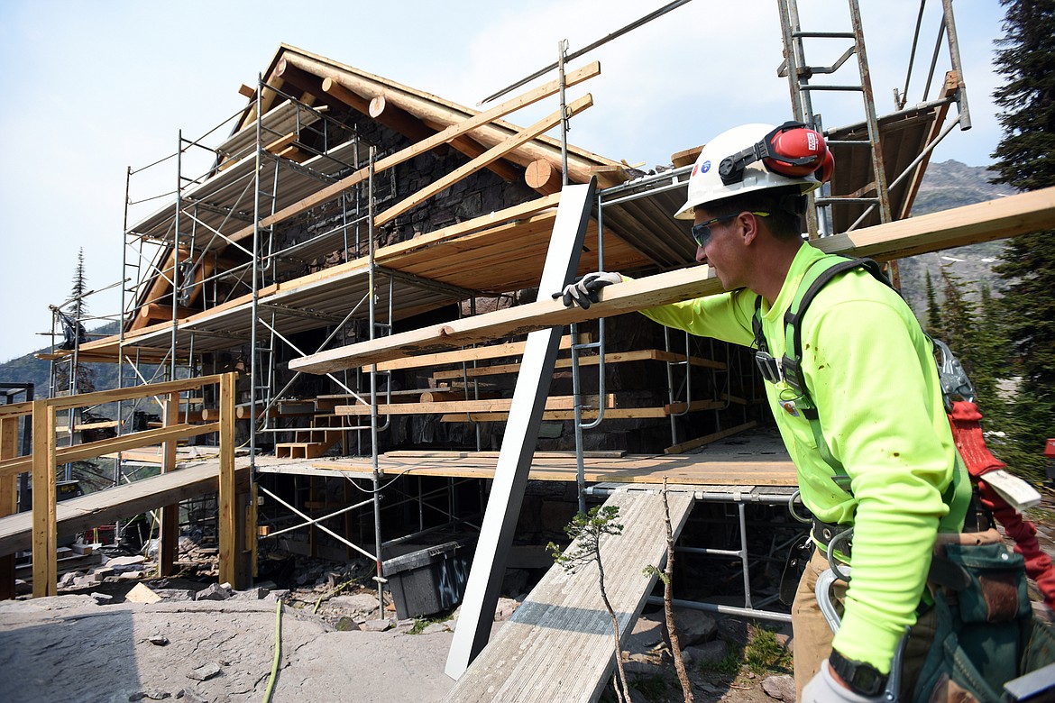 Nick DeLude, with Dick Anderson Construction, carries supplies up to the catwalk at Sperry Chalet in Glacier National Park on Thursday, Aug. 8. (Casey Kreider/Daily Inter Lake)