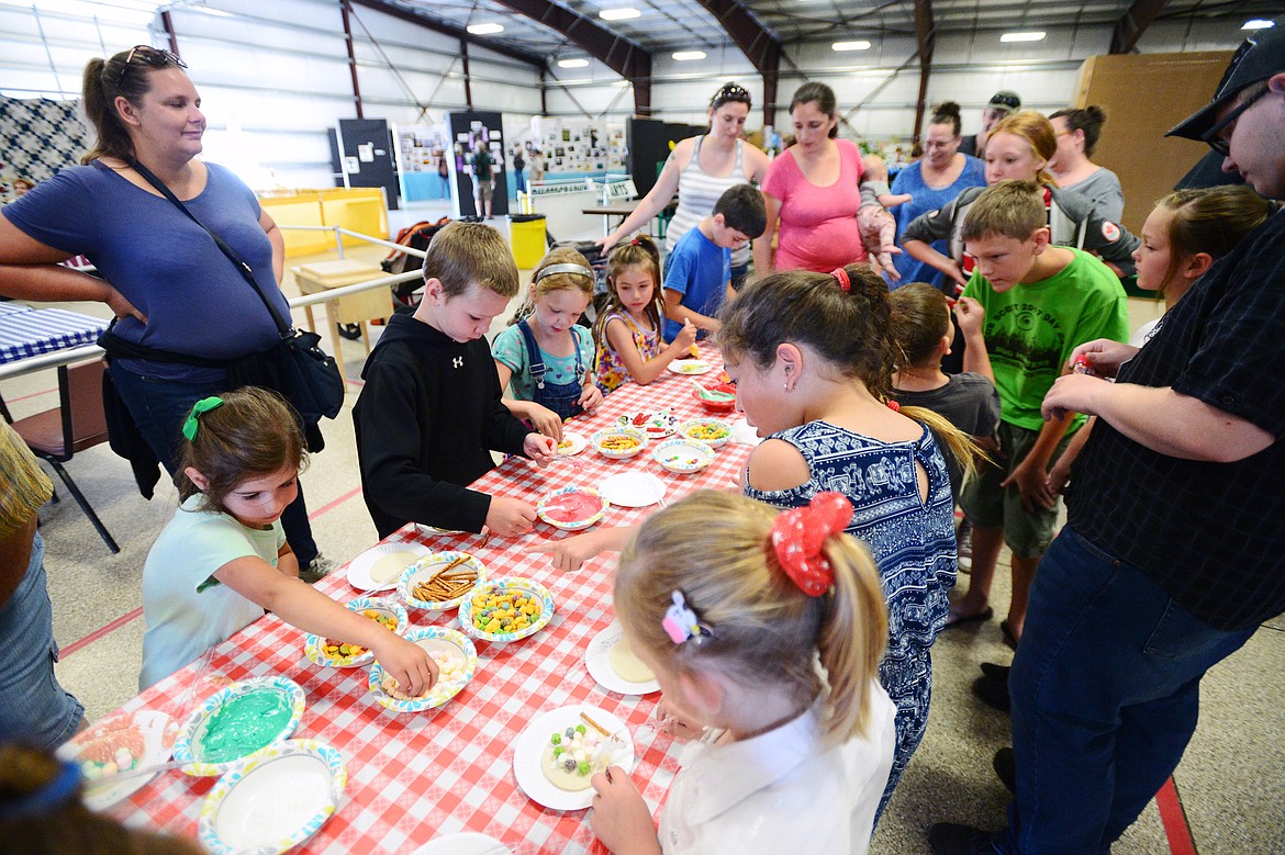 Kids add colorful toppings to their cookie creations at the Crafty Cookie Contest at the Northwest Montana Fair &amp; Rodeo on Thursday. (Casey Kreider/Daily Inter Lake)