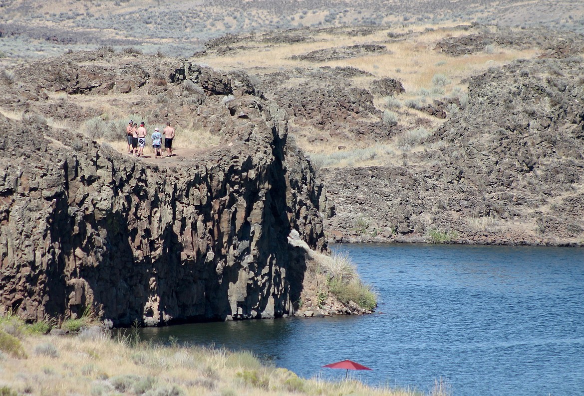 Casey McCarthy/Columbia Basin Herald 
Above: Visitors stand atop one of the many cliffsides that stand above the lake waters. Below: The trail around Billy Clapp Lake provides a great view of the reservoir and area that surrounds the water.