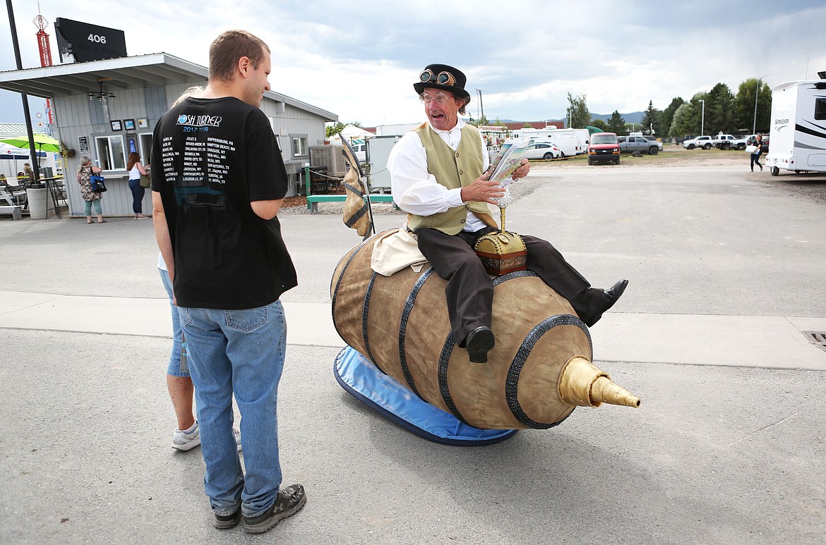 Physical comedian Bill Robison interacts with fair-goers on Thursday afternoon as part of his steam-punk, explorer persona. (Mackenzie Reiss/Daily Inter Lake)