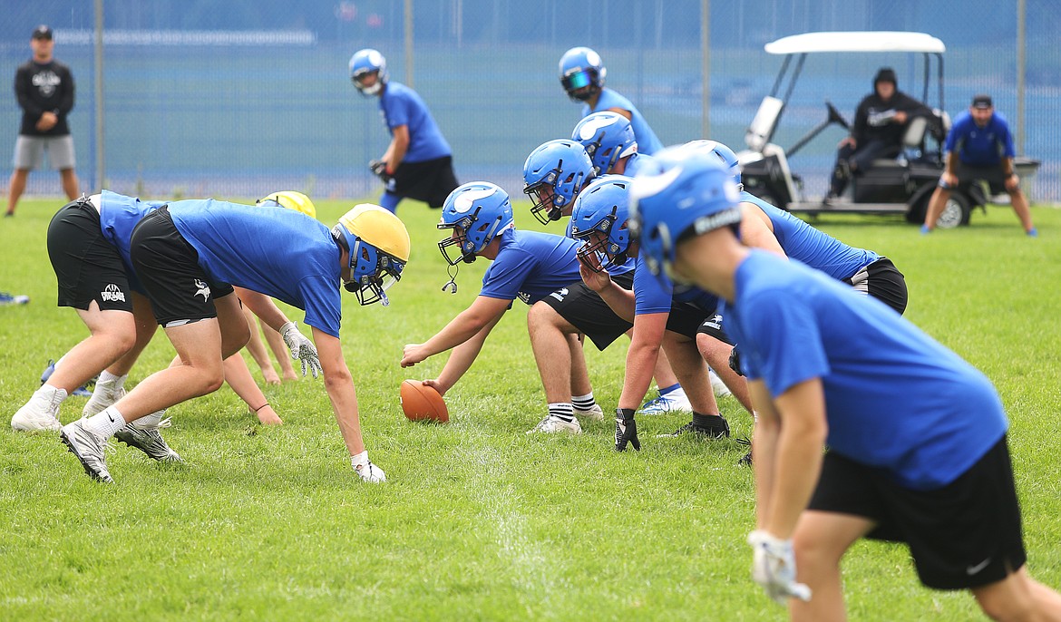 Football players get ready at the line of scrimmage before a play at practice Monday at Coeur d&#146;Alene High School. (LOREN BENOIT/Press)