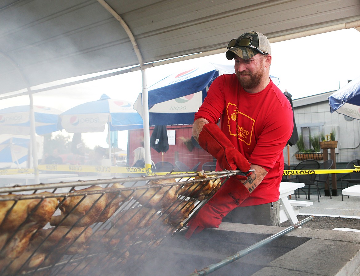 Shawn Parrish flips a rack of chicken at the Northwest Montana Fair in 2019. (Mackenzie Reiss/Daily Inter Lake file)