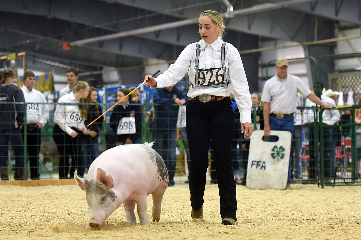 Alyssa Meeker, of Kalispell, guides her pig Missy around the arena during Swine Showmanship &amp; Market Swine Judging at the Northwest Montana Fair &amp; Rodeo on Wednesday. (Casey Kreider/Daily Inter Lake)