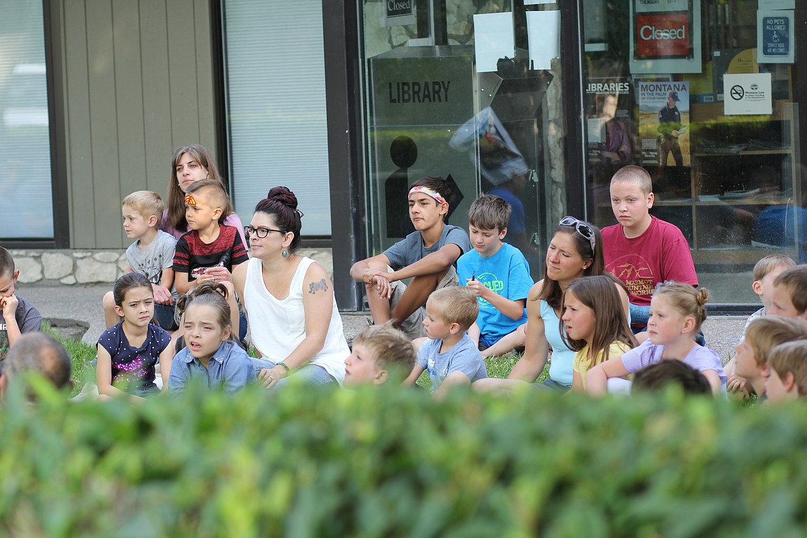 PARTICIPANTS OF all ages listening to Nikki Ericksen read a story at the Plains Library Summer Reading Program party. (Photo credit Cheri Minemyer/Clark Fork Valley Press)