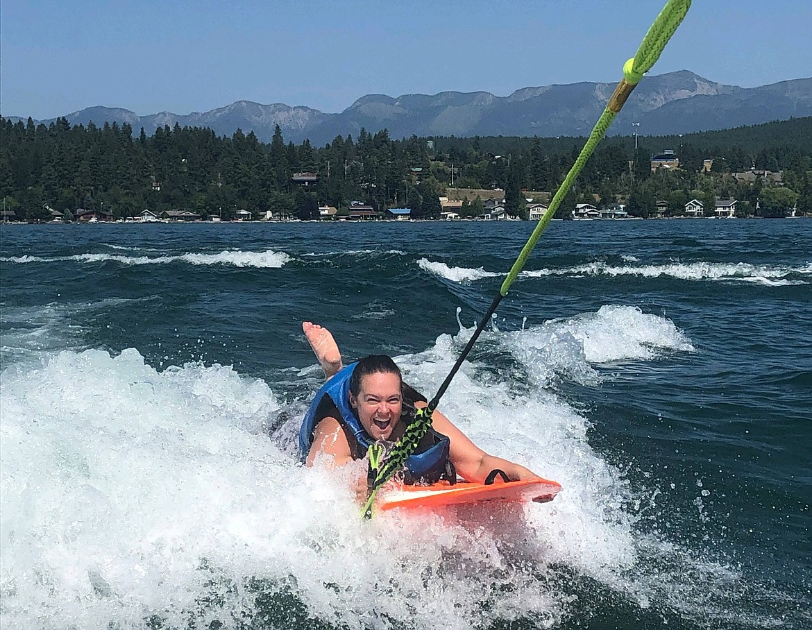 An athlete is all smiles as she wakesurfs on Flathead Lake. (Courtesy of Starla Hilliard-Barnes)