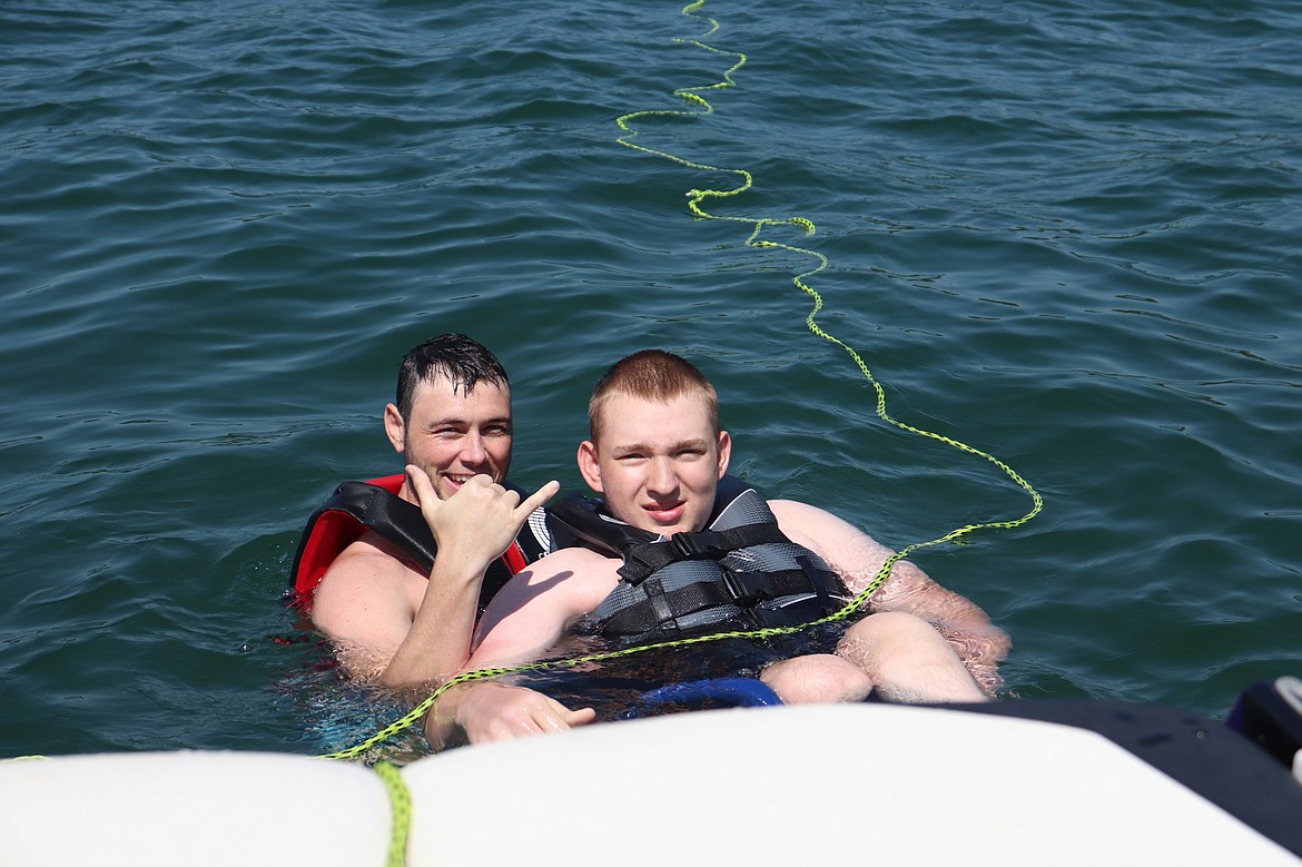 Moving Forward Adaptive Sports volunteer Joey Goetsch, 28, of Kalispell assists athlete Tristan Dishon, 15, of Kalispell on the adaptive wakeboard. (Courtesy of Starla Hilliard-Barnes)