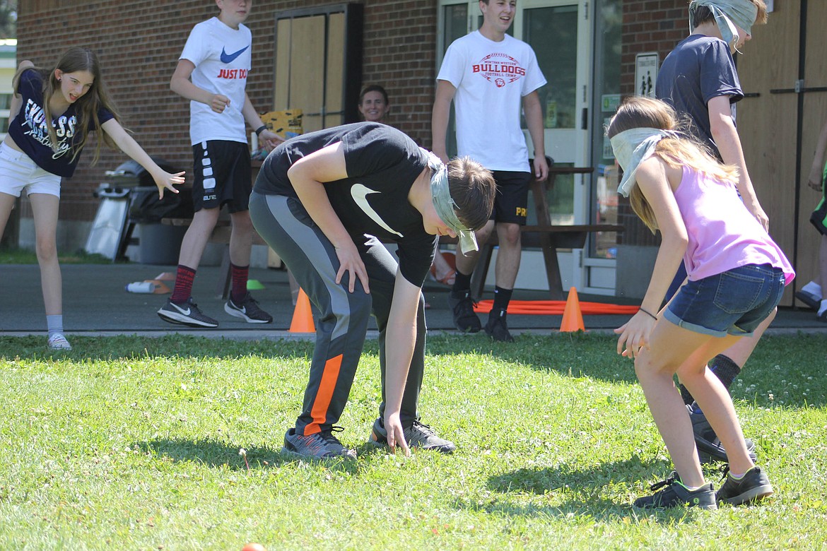 Eighth-grader Ben Lohman and sixth grader Lilly Sansom participate in teen team building activities in St. Regis on Tuesday, August 6. (Maggie Dresser/Mineral Independent)