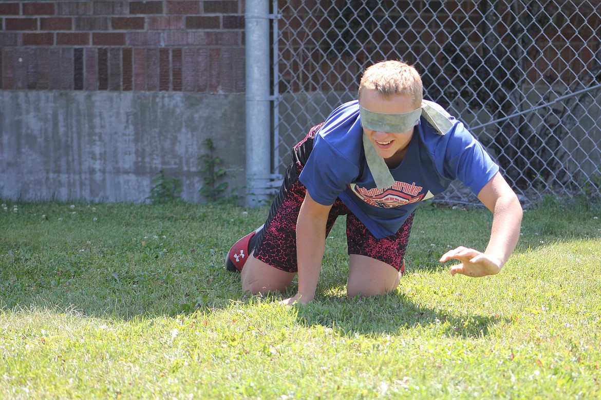 John Pruitt, an eighth-grader, searches for an object while blind-folded. (Maggie Dresser/Mineral Independent)