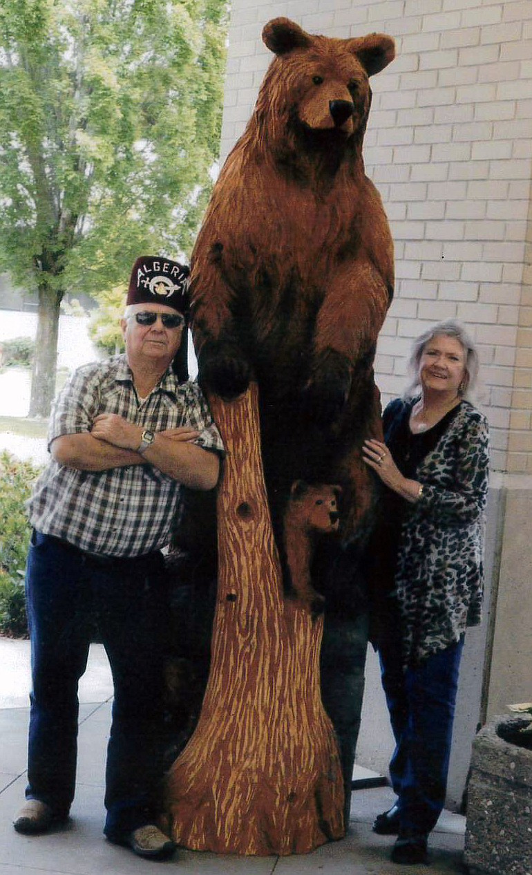 KERMIT ANDERSEN poses with the bear that he donated to the Shrine Hospital. Andersen won the bear in an auction for $4,000 in the Chainsaw Carving Rendezvous in Ronan. (courtesy photo)