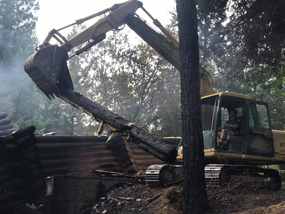 Photo by NORTH BENCH FIRE
Mike Kelly provided an excavator to help remove logs that were hindering the efforts of firefighters and investigators.