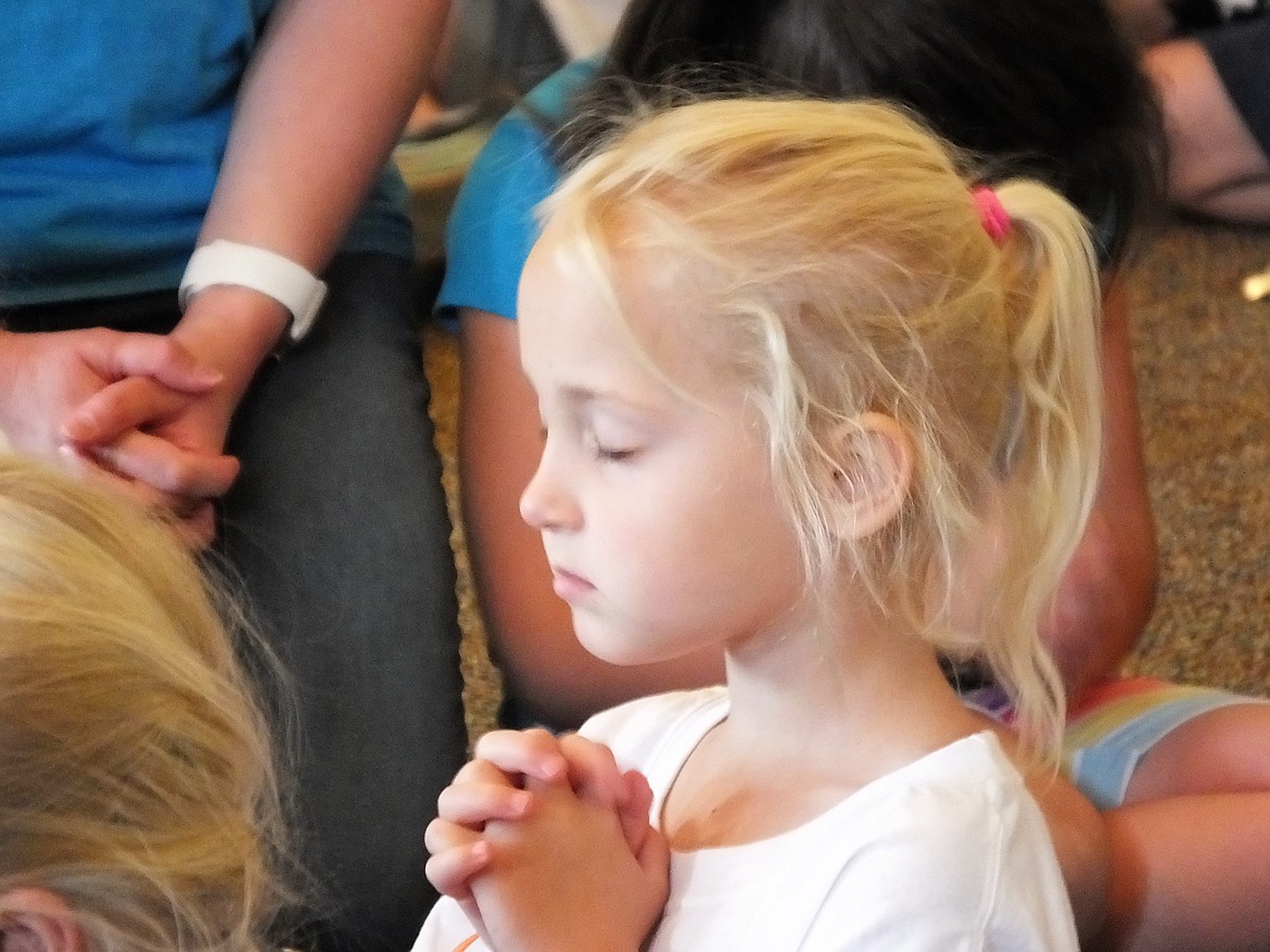 PRAYING AT the Roar! Vacation Bible School hosted at the Plains Bible Chapel. (Photo Credit Marla Burgess/Clark Fork Valley Press)