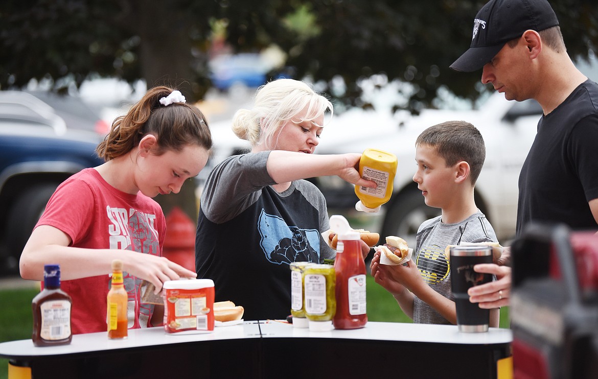 Ary and Sommer Dalton of Kalispell and their children Rhoday, 14, left, and Coen, 12, load up their Oscar Mayer hot dogs as the Wienermobile visits Kalispell on Friday at Super 1 Foods. Coen has wanted to see the famous Wienermobile since he was 4 years old.
(Brenda Ahearn/Daily Inter Lake)