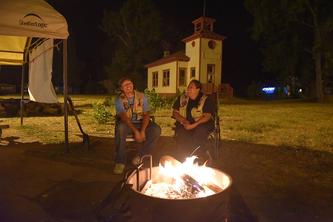 MITCHELL PARKER, and Lacey Burke enjoy the night shift at the Ravalli boat inspection site. Though peaceful, they have faced snow, rain, floods, and a bear while they stay ever vigilant to inspect all boats going by for invasive mussels. (Carolyn Hidy/Lake County Leader)