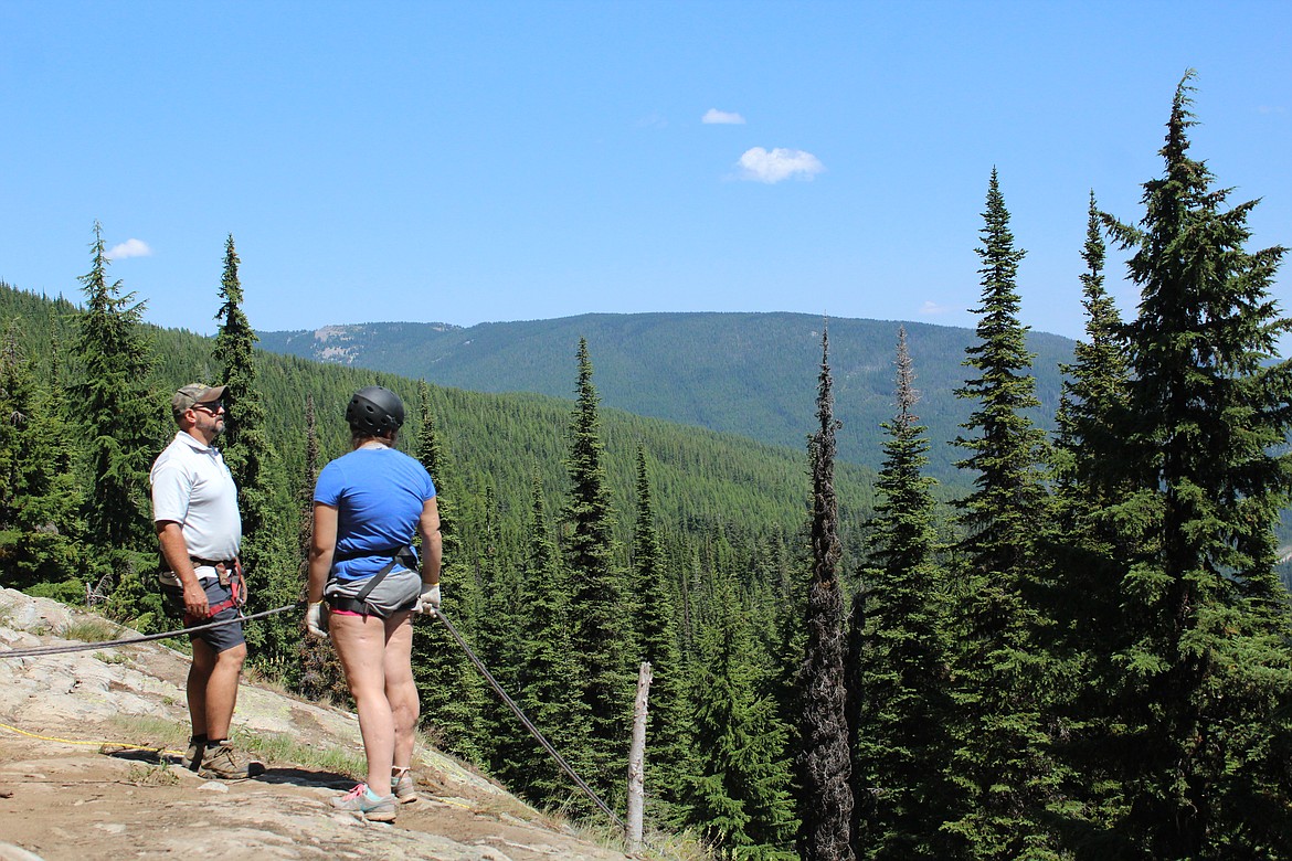 BOB THORNHILL and Marcella VanHuss looking out of the Blossom Lake trail before she is about to repell 70 feet. (John Dowd/Clark Fork Valley Press)