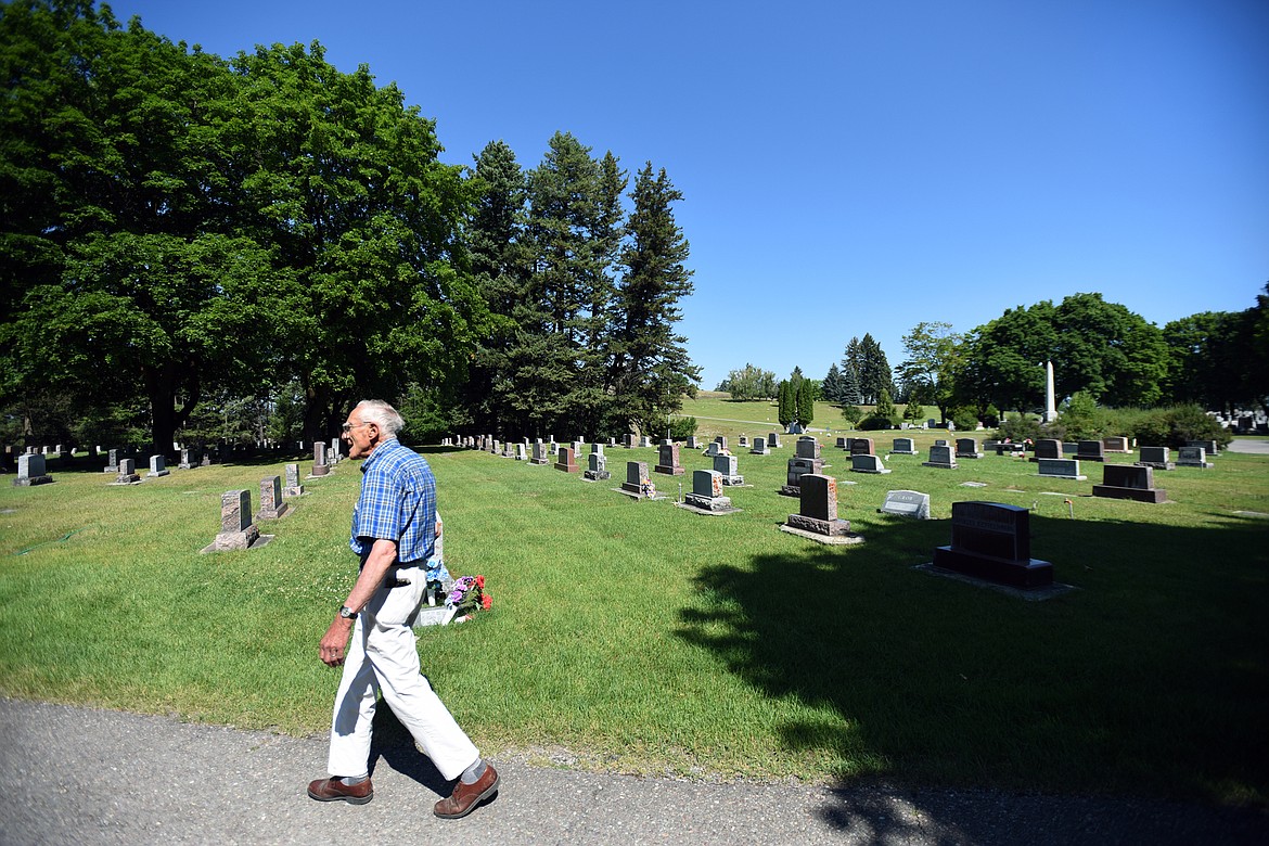James Korn, sexton at C.E. Conrad Memorial Cemetery, walks along rows of gravestones on the cemetery&#146;s grounds in Kalispell on Thursday, Aug. 1. (Casey Kreider photos/Daily Inter Lake)
