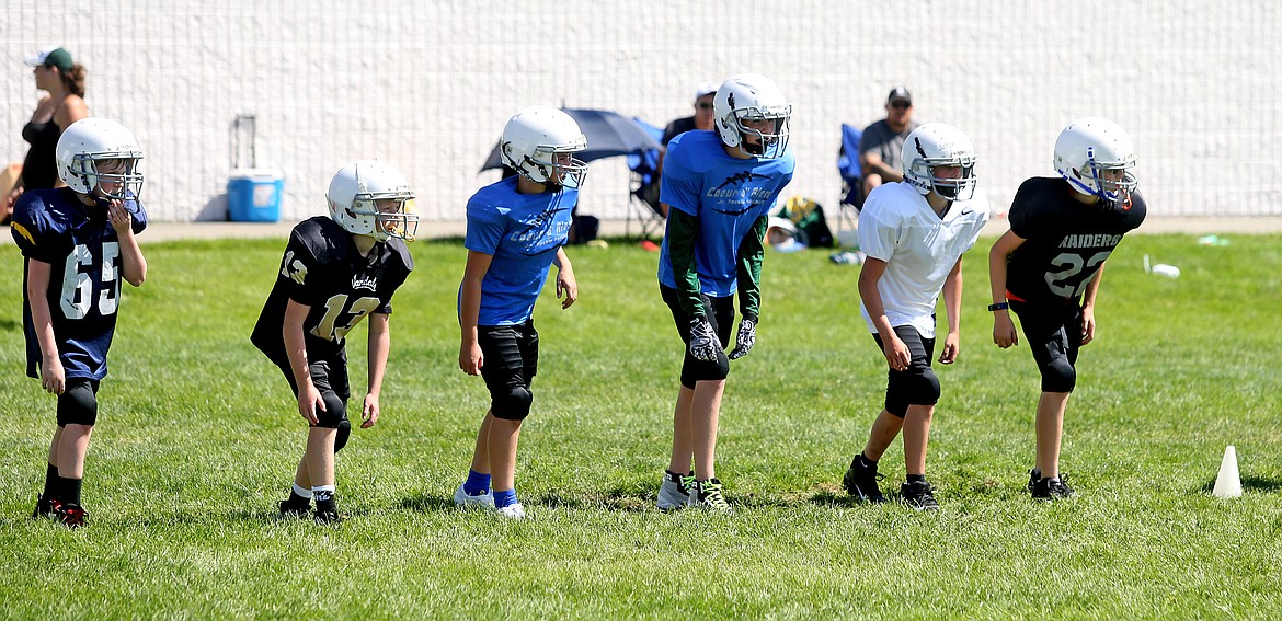 Local area middle school students line up at the line of scrimmage during a wide receiver drill at Coeur d&#146;Alene High School&#146;s Junior Tackle camp last Tuesday.