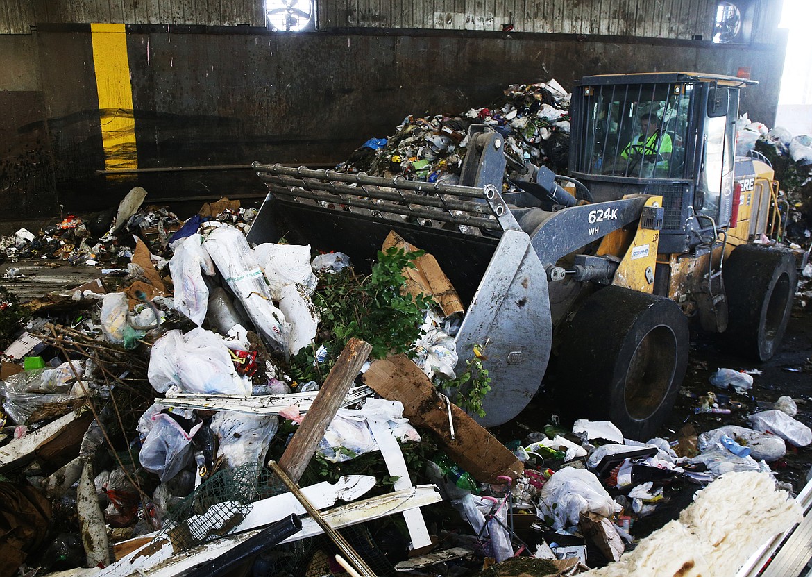 John Rowe uses a loader to move trash into a waste handler dump at Kootenai County Solid Waste Transfer Station last fall. Most of the county's solid waste fees are proposed to decrease on Jan. 1, 2020.  (LOREN BENOIT/Press File)