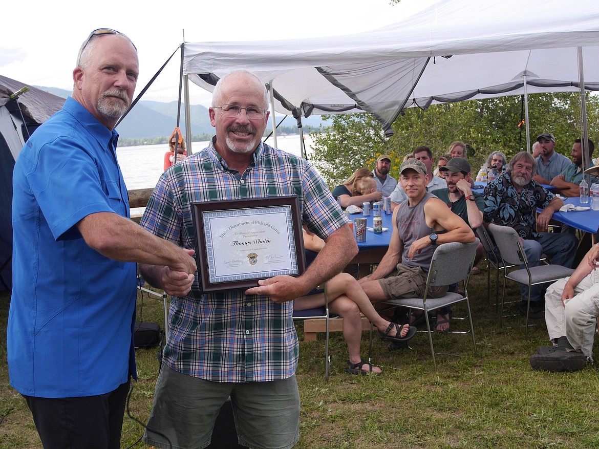 (Photo by DWAYNE PARSONS)
Idaho Department of Fish &amp; Game Director Ed Schriever presents a plaque to Tom Whalen for appreciation of his 31 years of service as an exceptional conservation officer.