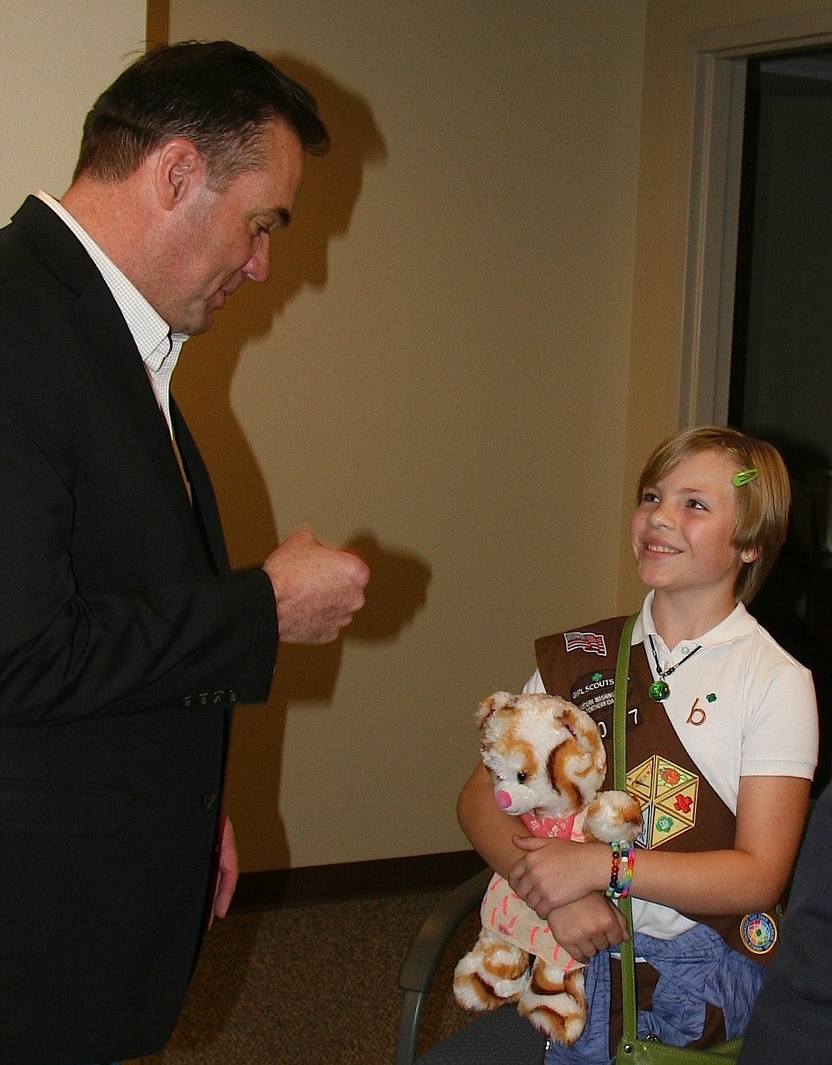 Rep. Russ Fulcher, R-Idaho, congratulates Girl Scout and Ramsey Elementary student Ilexa Paszczynska with a fist bump on her achievements on Thursday at his office in Coeur d&#146;Alene. (BRIAN WALKER/Press)