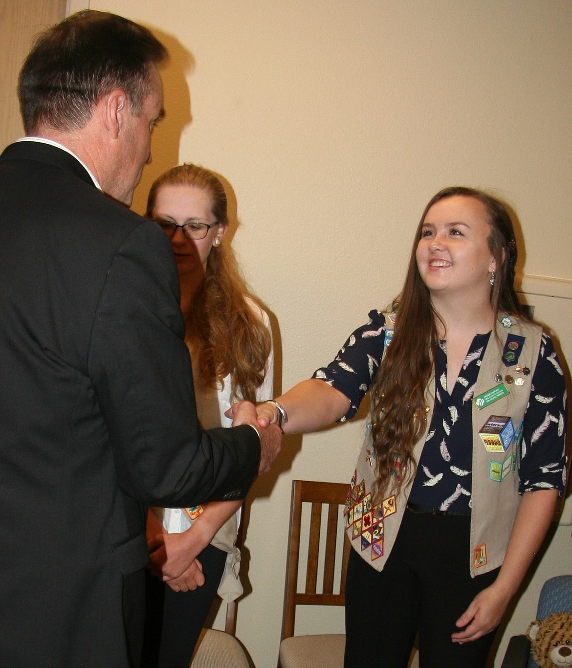 Rep. Russ Fulcher, R-Idaho, greets Girl Scouts Caitlyn Smith, middle, and Jacquelyne Duncan at his office in Coeur d&#146;Alene on Thursday. Smith is a Sandpoint High student, while Duncan attends Lake City High. (BRIAN WALKER/Press)