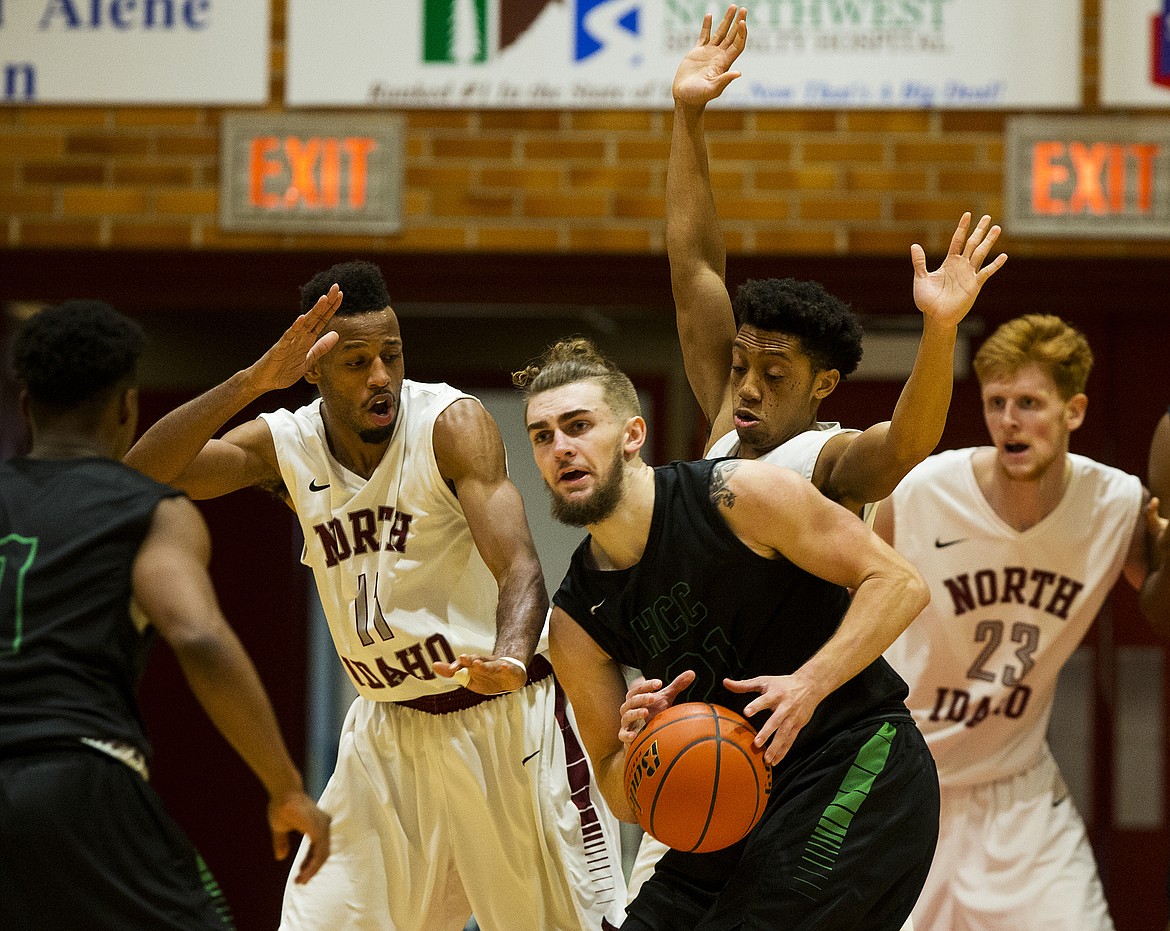 LOREN BENOIT/Press file
Highline College guard Coby Rothwell looks for a teammate as North Idaho College defenders add pressure in this 2017 photo.