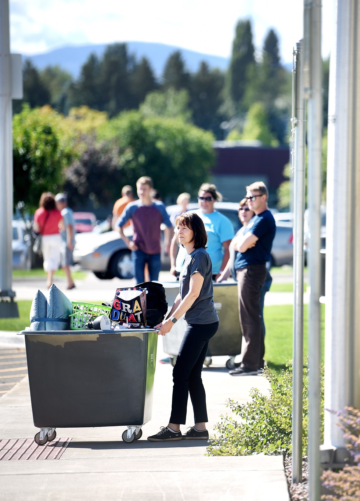 Executive Director of Human Resources Karen Glasser helps students unpack their cars and get moved into the dorms on Monday.