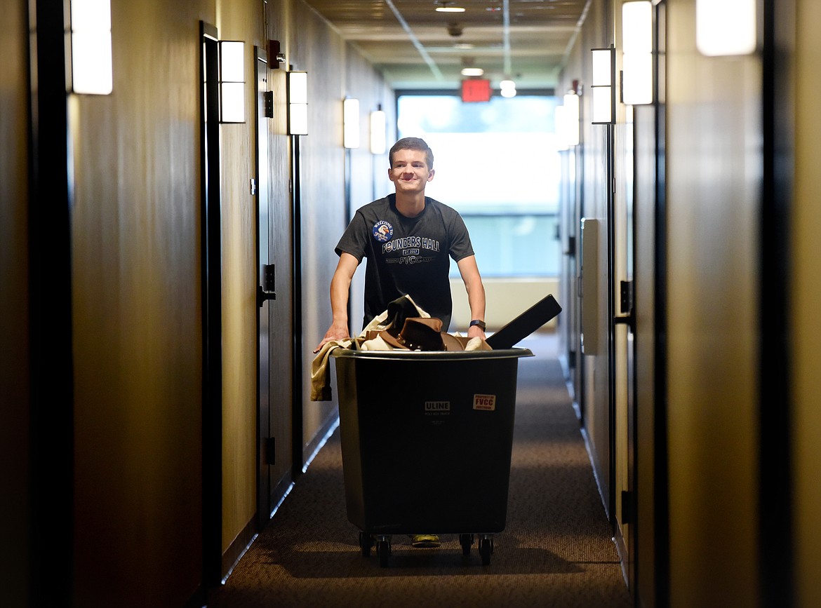 Emmett Jeschke moves a crate of items into the dorms on Monday morning, August 26, at Flathead Valley Community College.(Brenda Ahearn/Daily Inter Lake)