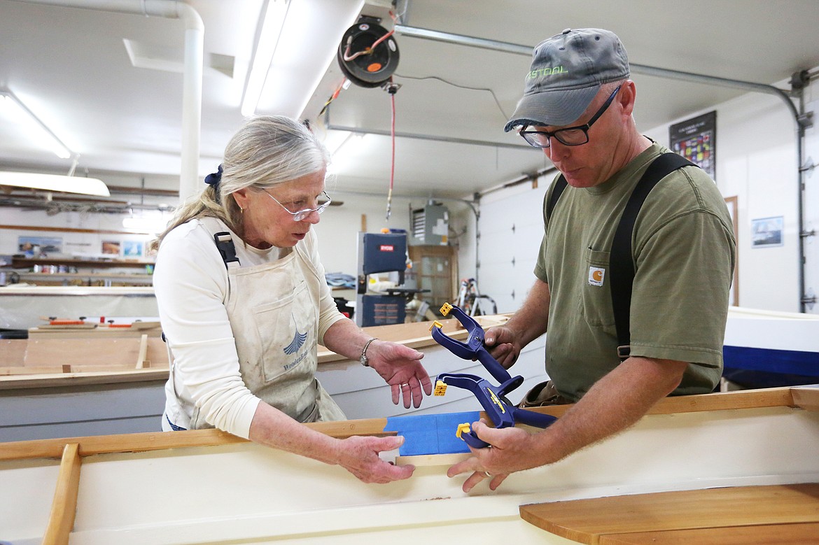 Susan Timmons and Vince Gordon collaborate on Timmon&#146;s wooden sailboat on Tuesday, Aug. 20. (Mackenzie Reiss/Daily Inter Lake)