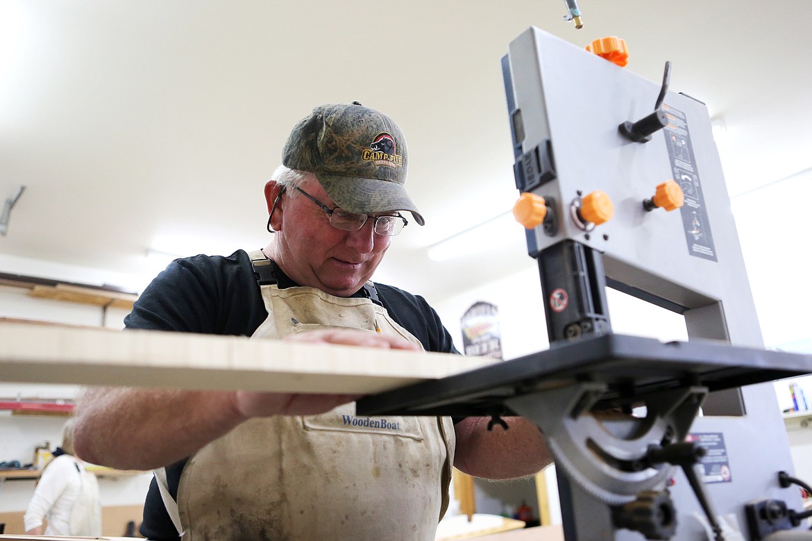 Frank Charboneau, of Bigfork, cuts a piece of wood during a wooden boat building class on Tuesday in Lakeside. (Mackenzie Reiss/Daily Inter Lake)