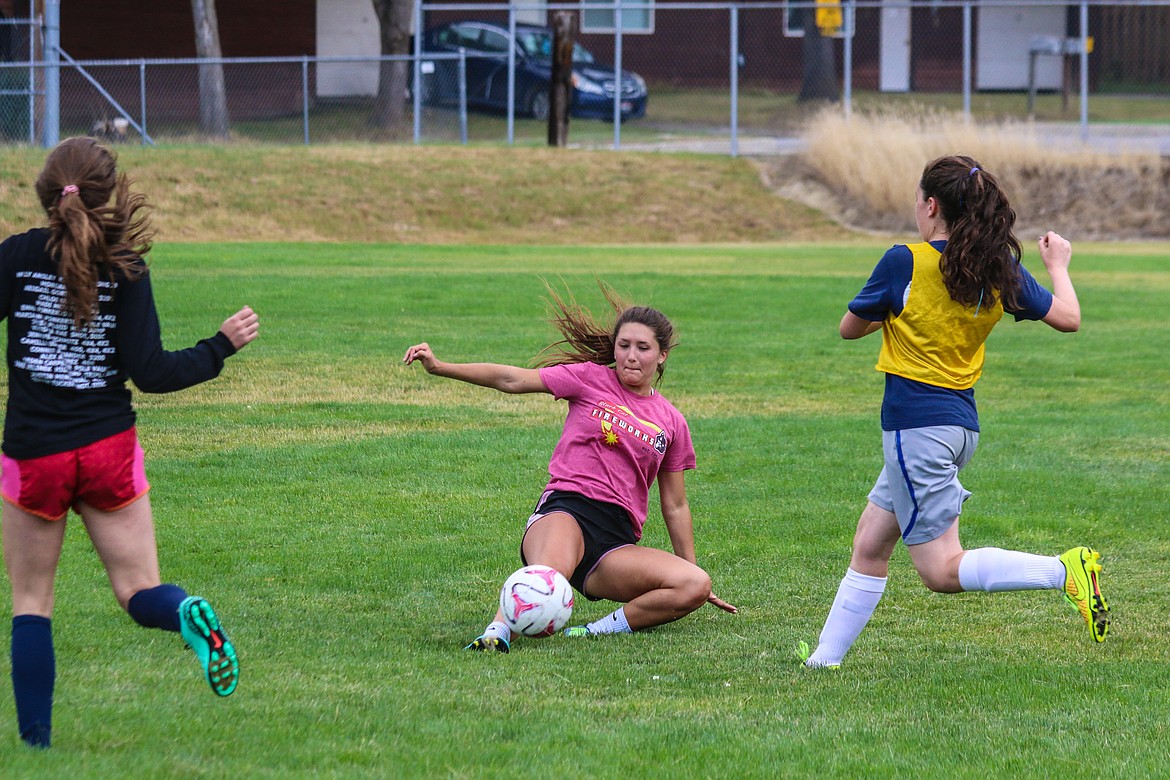 Makayla Mierke slides to play the ball during a recent girls&#146; soccer practice.