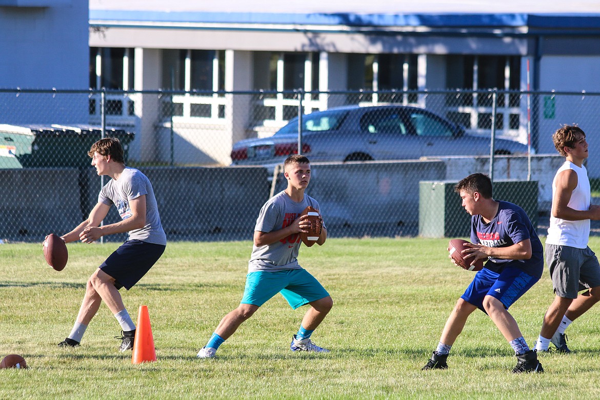 The Bonners Ferry quarterbacks, Eli Richards, Teigan Banning, and Blake Rice, practicing for the 2019 football season.