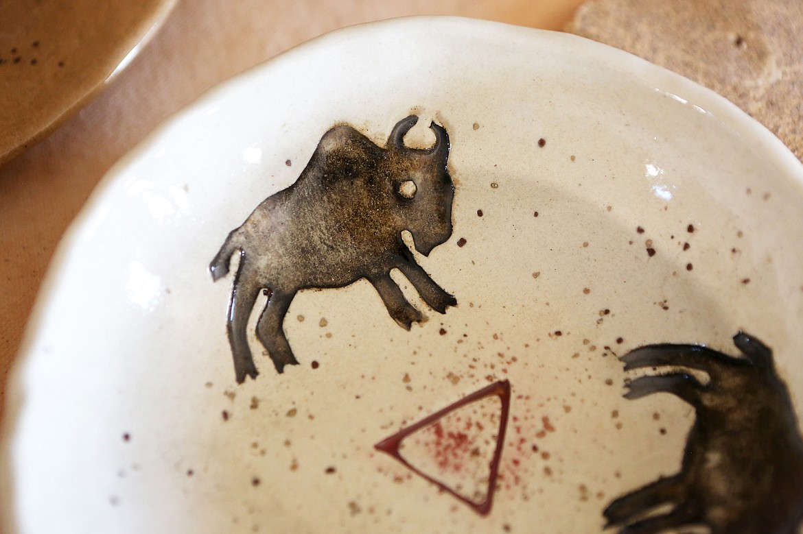 Fuson decorates her pottery with animal motifs.